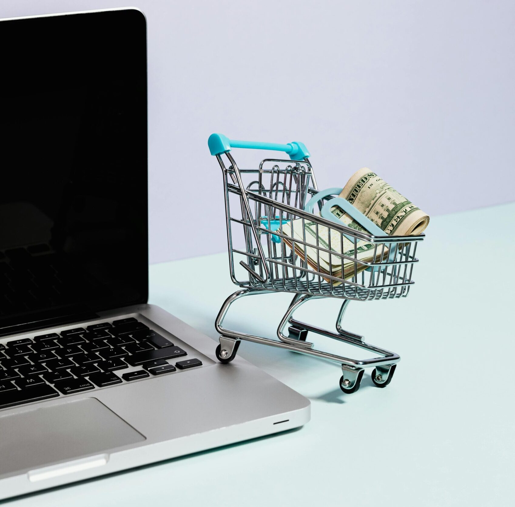 Photo by Photo By: Kaboompics.com: https://www.pexels.com/photo/shopping-cart-with-money-on-top-of-a-laptop-5632379/